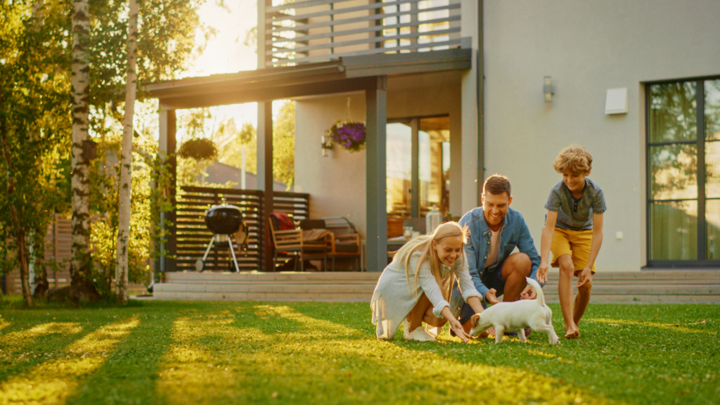 Family in front of home petting a new puppy